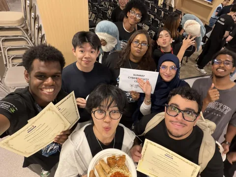 Club members, Yousof among them, after Engineering and Computing Xploration Week, holding their certificates of appreciation and a Sunway Cybersecurity Club sign